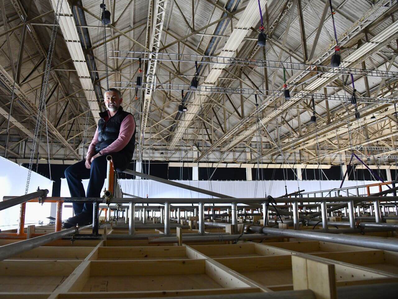 Tom on top of This England Set Tom Overton sitting atop the This England set structure inside the studio.