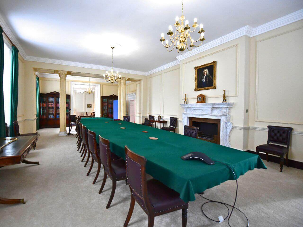 This England Finished Set - Panelling, Faux Marble Fireplace, Stone Columns Full view of This England cabinet room set featuring Georgian columns, wood panelling, and marble-effect fireplace.
