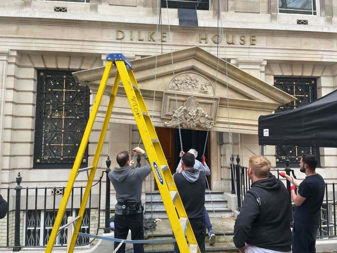 Scoop Set - Installing faux stone plinth for Epstein's Apartment set Film crew and cast on location at the finished Totom-built The Take set.