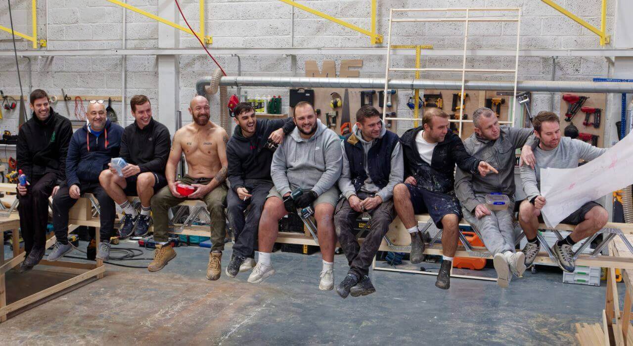 Totom Crew posing for new website photo Group shot of Totom crew sitting together in the workshop.