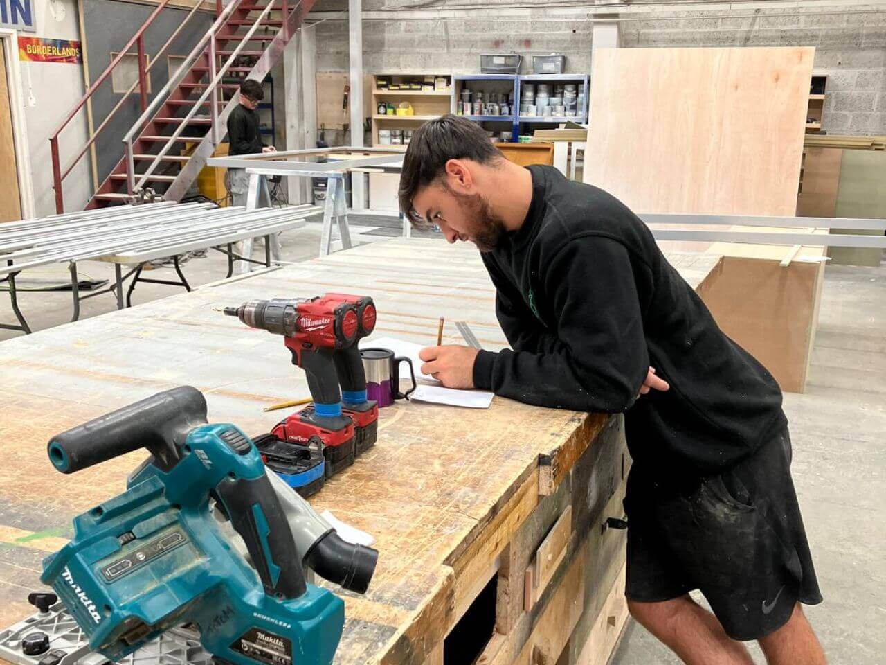 Rocco Learning the Trade Rocco working in the Totom workshop, surrounded by carpentry tools.