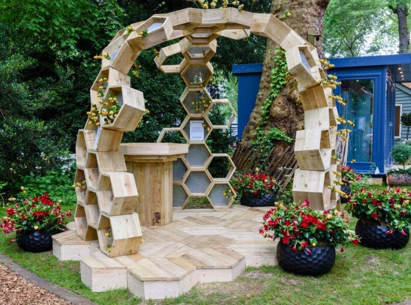 Sculptural Build for Chelsea Flower Show Wooden honeycomb structure installation at Chelsea Flower Show with integrated planting and seating