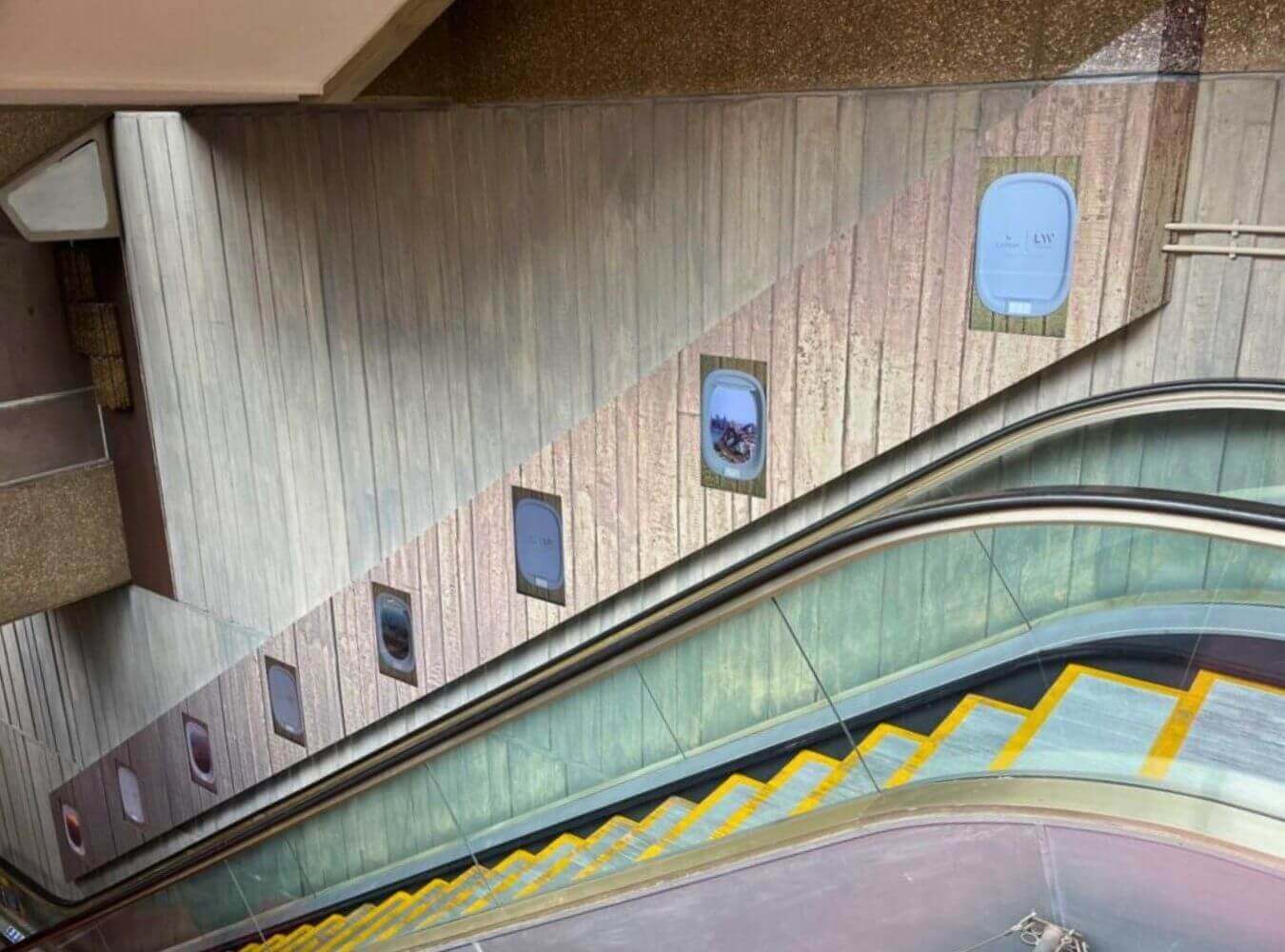 Escalator Wrap Installation at London Palladium Scenic wall and escalator installation inside London Palladium with branded panels and integrated display graphics