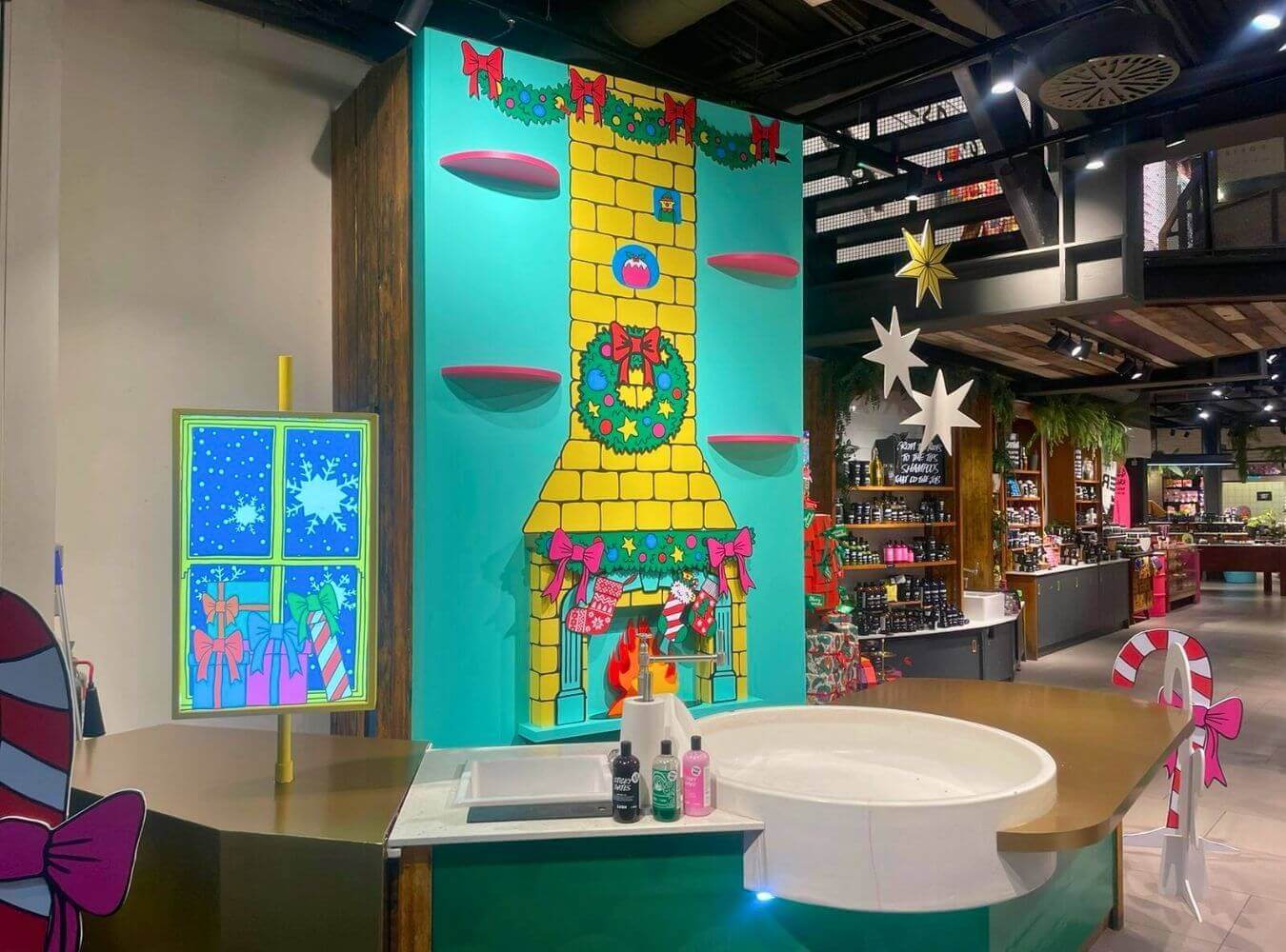 Christmas Retail Installation for Lush Bright, illustrated Christmas-themed retail display with fireplace backdrop and custom-built sink unit in Lush store