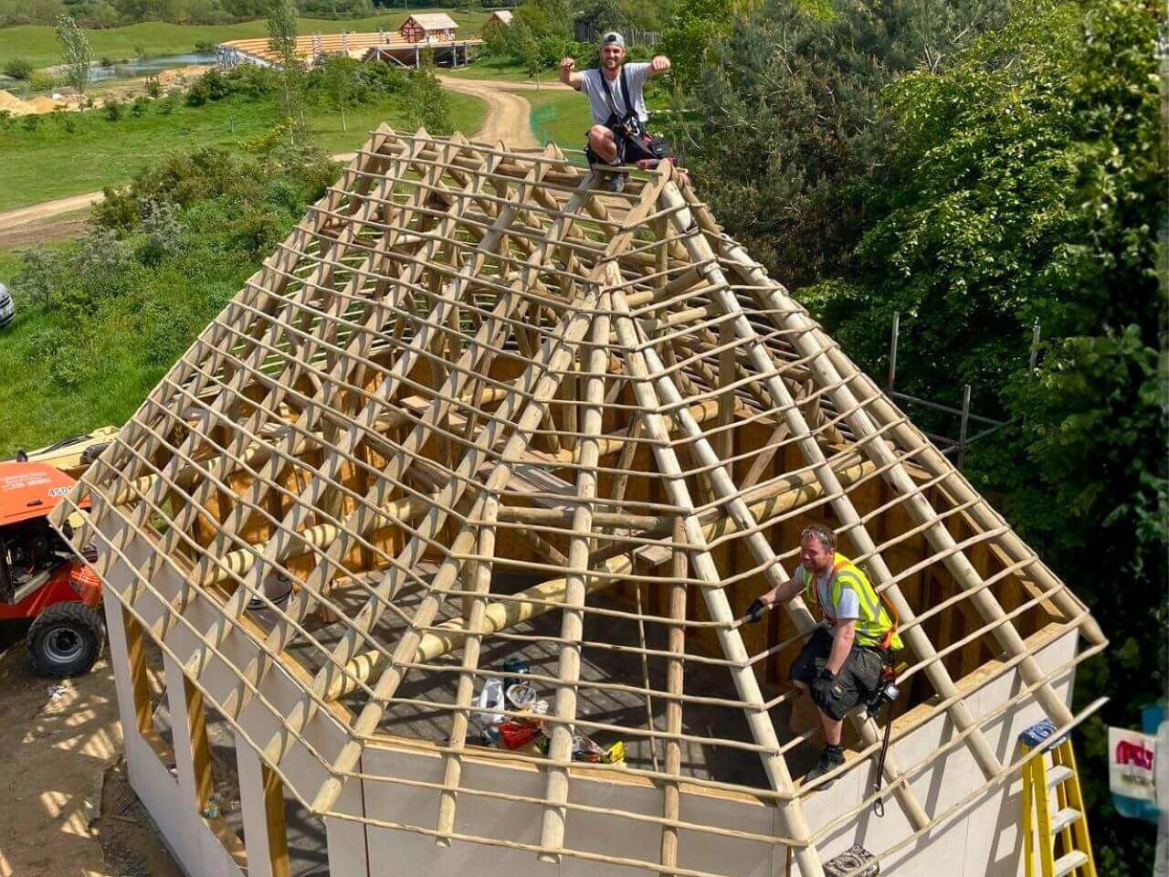 4 Kynren Viking Village Roof Structure Large rustic timber roof frame under construction at Kynren, with roundwood rafters and roof battens being installed.