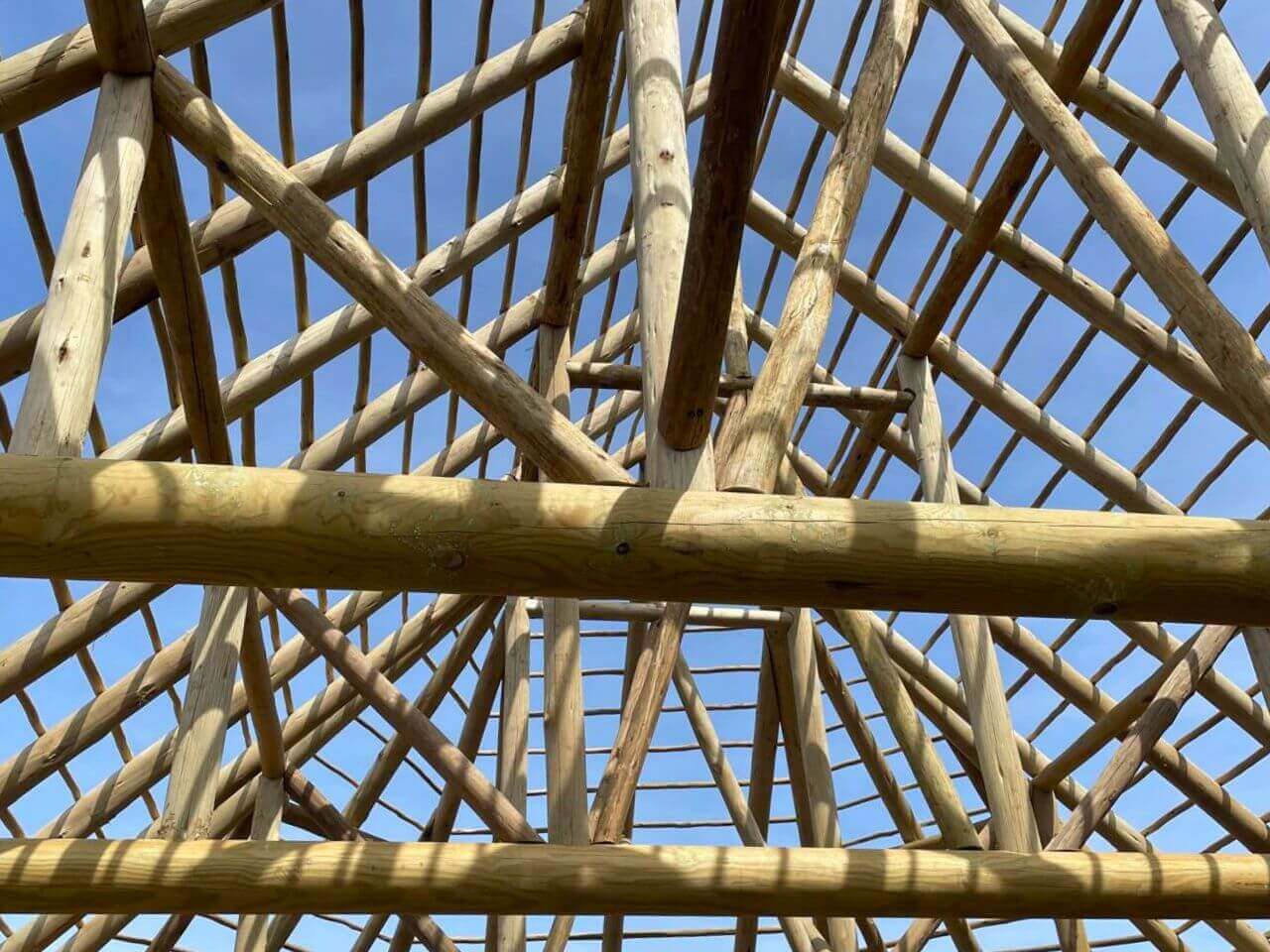 5 Roundwood Timber Joinery Detail Interior view of the Kynren Viking Village roof frame showing natural roundwood timbers, rafters and traditional timber connections.
