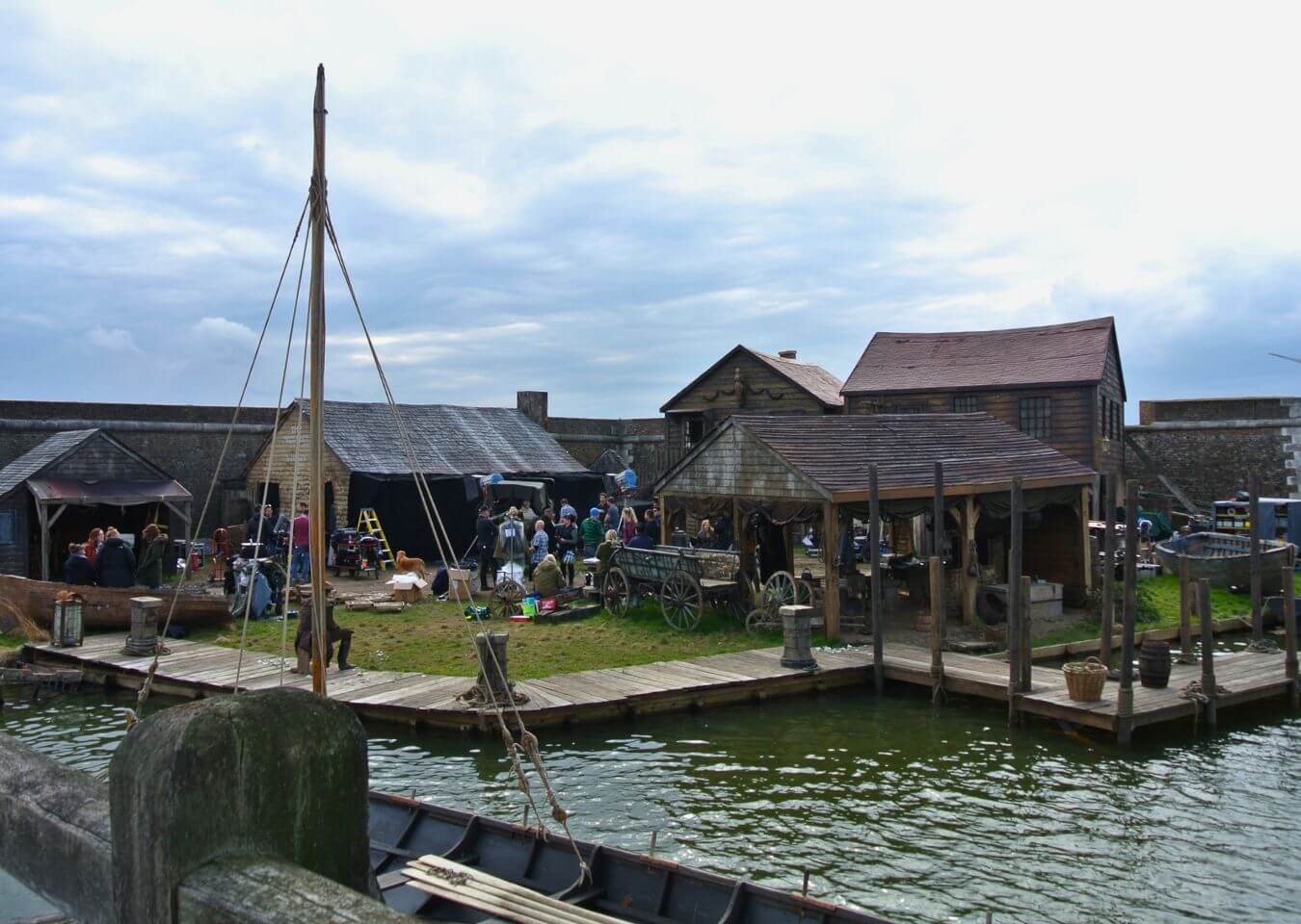 Dockside set build for Taboo at Tilbury Fort Dockside set for Taboo with timber buildings, working quay, rigging, crew and water visible.